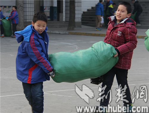 襄阳市大庆路小学捐300编织袋旧衣服给贫困儿